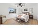 Bright bedroom with a queen-size bed, light wood floors and ceiling fan at 4441 E Montana Pl, Denver, CO 80222