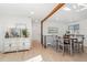 Light-filled dining area with a wooden table and gray chairs near the kitchen at 4441 E Montana Pl, Denver, CO 80222