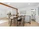 Bright dining area with wooden table, gray chairs, and a view of the bathroom at 4441 E Montana Pl, Denver, CO 80222