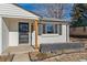 Front entry with a modern door and wood post at 4441 E Montana Pl, Denver, CO 80222