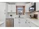 White kitchen with subway tile backsplash and stainless steel appliances at 4441 E Montana Pl, Denver, CO 80222