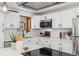 Modern kitchen with white cabinets, quartz countertops and a stainless steel range at 4441 E Montana Pl, Denver, CO 80222