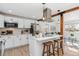 Modern kitchen with white cabinets, island, and stainless steel appliances at 4441 E Montana Pl, Denver, CO 80222