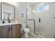 Modern bathroom with a glass enclosed shower, neutral tile, and updated fixtures at 4125 Tejon St, Denver, CO 80211