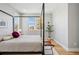 Minimalist bedroom featuring a modern bed frame, large windows, and decorative accents at 4125 Tejon St, Denver, CO 80211