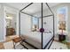 Bright bedroom featuring a four-poster bed, large windows and an ensuite bathroom at 4125 Tejon St, Denver, CO 80211