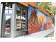 Exterior shot of Cherry Bean Coffee shop, featuring a brick facade and mural at 4125 Tejon St, Denver, CO 80211