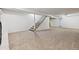 Expansive carpeted basement featuring finished stairs and neutral walls, offering a versatile living space at 5800 W Warren Ave, Denver, CO 80227