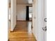 Inviting hallway with gleaming hardwood floors and a clear view into adjacent spaces at 5800 W Warren Ave, Denver, CO 80227