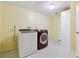 Functional laundry room featuring a washer, dryer, white walls, and practical flooring for easy maintenance at 5800 W Warren Ave, Denver, CO 80227