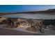 Stunning home with three-car garage and beautiful water and mountain views at dusk at 2891 Waterfront Dr, Monument, CO 80132