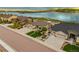 Aerial shot of home with front lawn, driveway, and a scenic view of the lake at 2891 Waterfront Dr, Monument, CO 80132