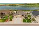 Beautiful home showcasing a manicured front yard near a lake and green landscape at 2891 Waterfront Dr, Monument, CO 80132