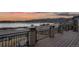 Expansive back deck showcasing peaceful water and mountain views at sunset at 2891 Waterfront Dr, Monument, CO 80132