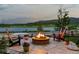 Cozy backyard fire pit area with comfortable seating, lush landscaping, and stunning natural views at 2891 Waterfront Dr, Monument, CO 80132