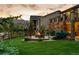 Beautiful backyard with a lush lawn, a firepit, mature landscaping and mountain views at 2891 Waterfront Dr, Monument, CO 80132