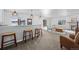 Walkout basement with a bar, counter seating, a stone pillar, and ample natural light at 2891 Waterfront Dr, Monument, CO 80132