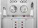 Modern bathroom featuring dual sinks, granite counters, and updated vanity lighting at 2891 Waterfront Dr, Monument, CO 80132
