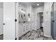 Bathroom featuring dual sinks, granite counters, modern vanity lighting, and a tiled floor at 2891 Waterfront Dr, Monument, CO 80132