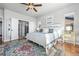 Light-filled bedroom with a ceiling fan, light hardwood floors, and an ensuite bath at 2891 Waterfront Dr, Monument, CO 80132