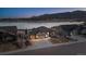 Aerial view of a charming house with mountain views, a three-car garage, and a landscaped front yard at 2891 Waterfront Dr, Monument, CO 80132