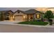 Charming single-Gathering home featuring a stone facade, well-manicured lawn, and a three-car garage at 2891 Waterfront Dr, Monument, CO 80132