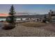 Front yard landscape featuring lake and mountain views, along with an outdoor firepit at 2891 Waterfront Dr, Monument, CO 80132
