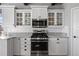 Close-up of a modern kitchen with stainless steel appliances, a range, and white cabinetry at 2891 Waterfront Dr, Monument, CO 80132