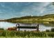 Peaceful lake view from a park bench with greenery and blue sky at 2891 Waterfront Dr, Monument, CO 80132
