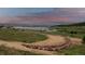 Expansive view of the community lake and walking paths, surrounded by lush greenery at 2891 Waterfront Dr, Monument, CO 80132