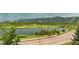 Scenic view of a calm lake surrounded by green hills and mountains at 2891 Waterfront Dr, Monument, CO 80132