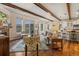 Inviting living room with exposed beams, hardwood floors, and panoramic views of the surrounding landscape at 2891 Waterfront Dr, Monument, CO 80132