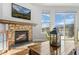 Living room with a stone fireplace, hardwood floors and views at 2891 Waterfront Dr, Monument, CO 80132
