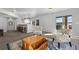 Open-concept living room featuring a bar area, gray walls, and sliding door to outside at 2891 Waterfront Dr, Monument, CO 80132