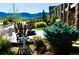 Landscaped patio with a firepit, Adirondack chairs, and lush plants at 2891 Waterfront Dr, Monument, CO 80132