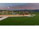 Community playground featuring swings, play structures, picnic tables and lush grassy areas at 2891 Waterfront Dr, Monument, CO 80132
