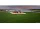 Community playground with green space, playground equipment, and a view of the lake at 2891 Waterfront Dr, Monument, CO 80132