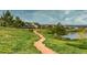 Picturesque walking path leading to a lake with community gazebo at 2891 Waterfront Dr, Monument, CO 80132