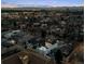Expansive aerial view captures the neighborhood and city skyline at dusk, highlighting surrounding buildings and city lights at 562 Steele St, Denver, CO 80206