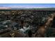 Picturesque aerial view of a residential area at dusk with illuminated buildings and streetlights under a twilight sky at 562 Steele St, Denver, CO 80206