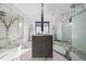 Modern bathroom featuring double vanity, marble floors, and glass enclosed shower at 562 Steele St, Denver, CO 80206