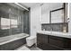 Modern bathroom with a bathtub, shower, and stylish tiled walls at 562 Steele St, Denver, CO 80206