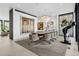 Elegant dining room with contemporary chandelier, large windows, and artistic decor at 562 Steele St, Denver, CO 80206