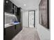 View of a modern hallway featuring a wet bar with mosaic backsplash and a glass door leading to the walk-in shower room at 562 Steele St, Denver, CO 80206