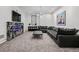 Spacious living room features a large sectional sofa, modern fireplace with black marble trim, and sleek decor for a comfortable space at 562 Steele St, Denver, CO 80206