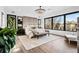 Bright main bedroom with large windows, chandelier, and ensuite bathroom access at 562 Steele St, Denver, CO 80206