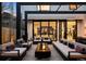 Modern outdoor patio area featuring contemporary furniture, a fire pit, and sliding glass doors at 562 Steele St, Denver, CO 80206