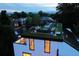 Elevated view of a rooftop deck featuring a lounge area and garden, with neighborhood views and scenic setting at 562 Steele St, Denver, CO 80206