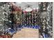 Stunning walk-in wine cellar showcases custom bottle racking, ambient lighting, and black marble accents under a decorative chandelier at 562 Steele St, Denver, CO 80206
