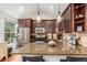 Well-equipped kitchen featuring stainless steel appliances, granite countertops, and stylish pendant lighting at 2841 N Columbine St, Denver, CO 80205